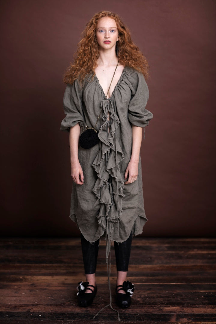 The Amano long line flounce dress has ruffles through the front with raw edging. Ties are used to fasten up and gather neck line and centre front. It has a raglan sleeve, side pockets and french seams throughout. This piece doubles up as a duster jacket.  Composition: pure linen  Crafted in Melbourne, Australia 